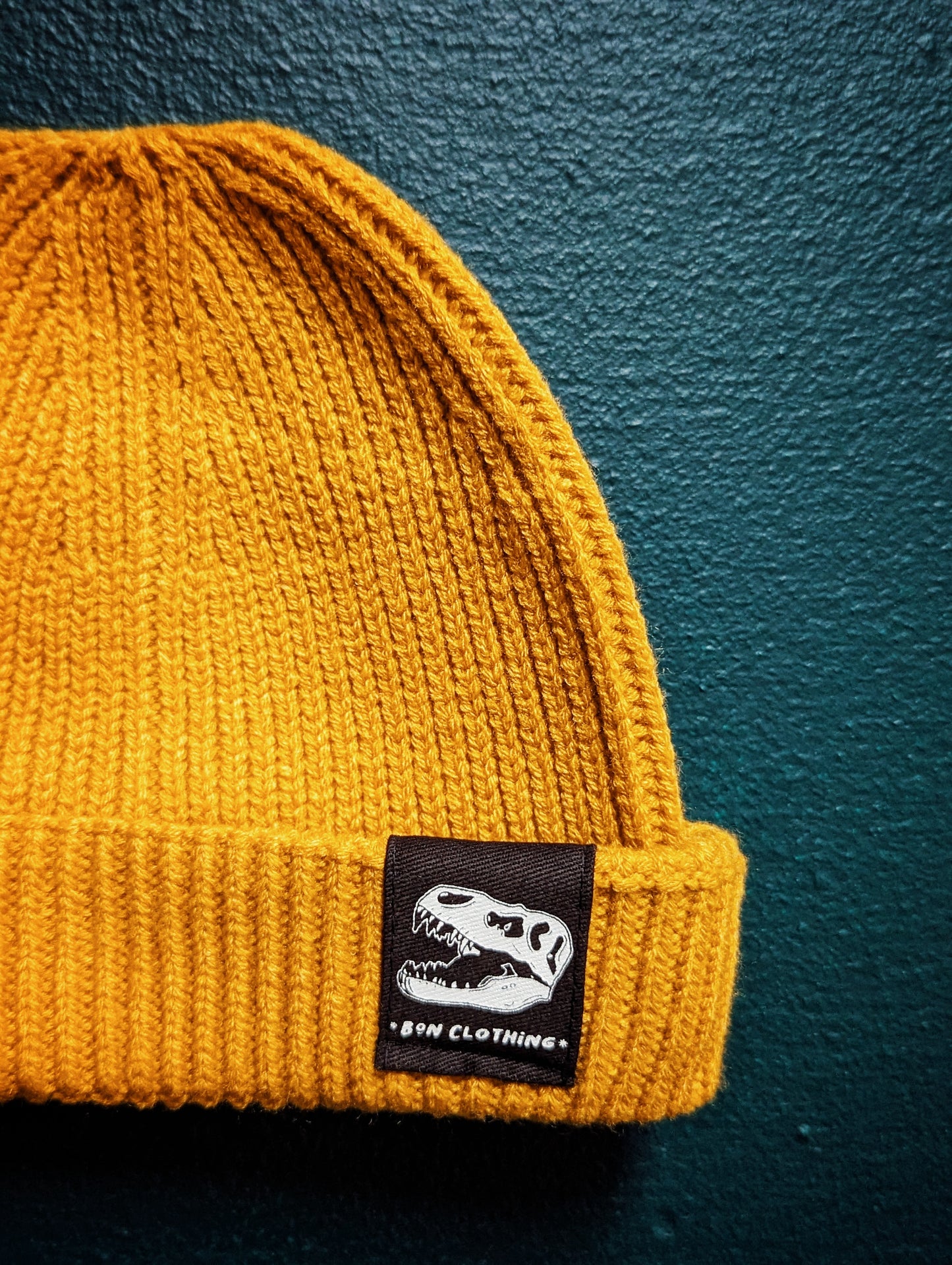 RECYCLED, ORGANIC HARBOUR STYLE BEANIES WITH T-REX PATCH.